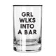GRL WLKS INTO A BAR ROCKS GLASS