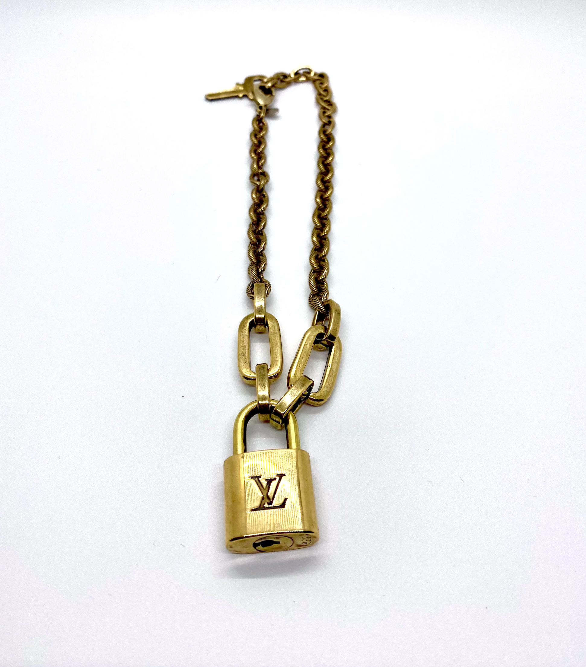 Gold louis vuitton lock on sale necklace